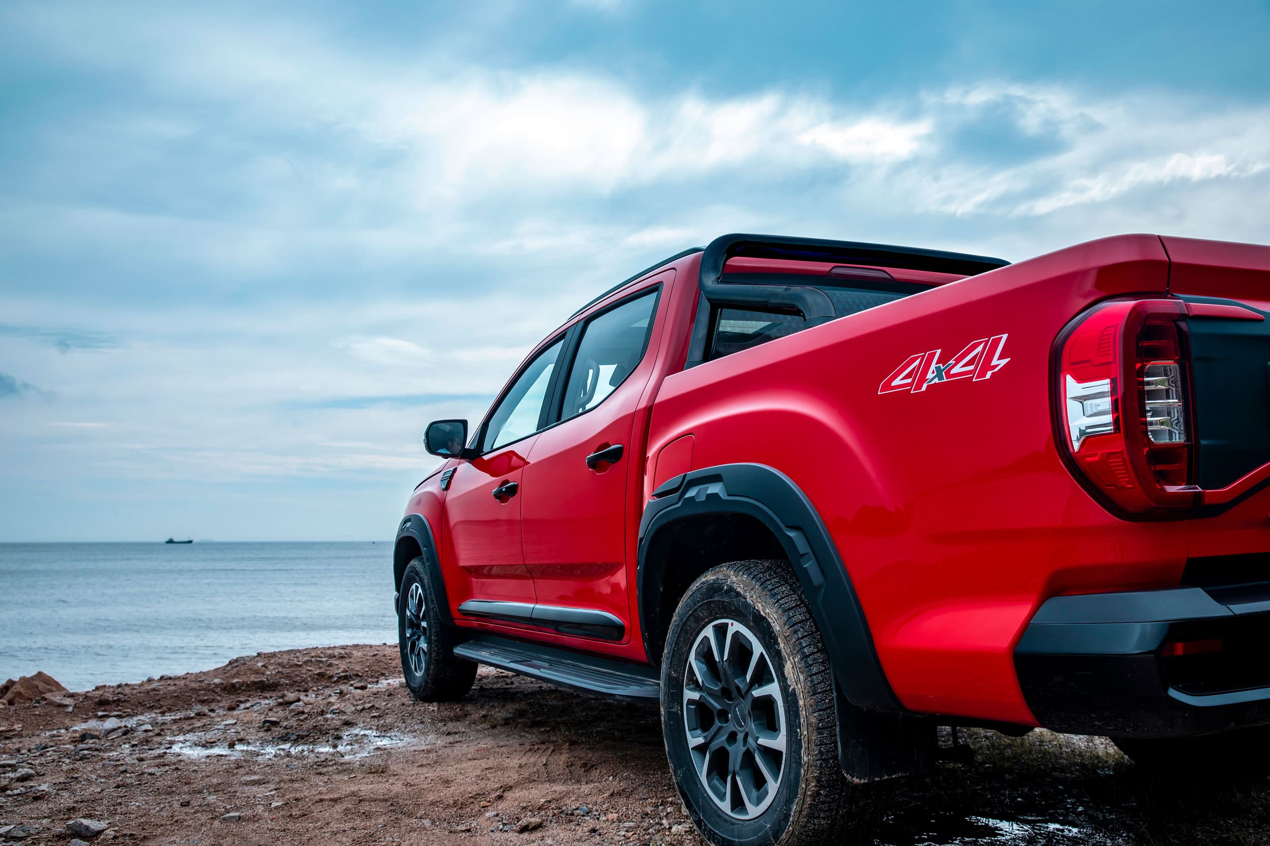 Maxus T60 Max sideview with view on sea (chinese red)