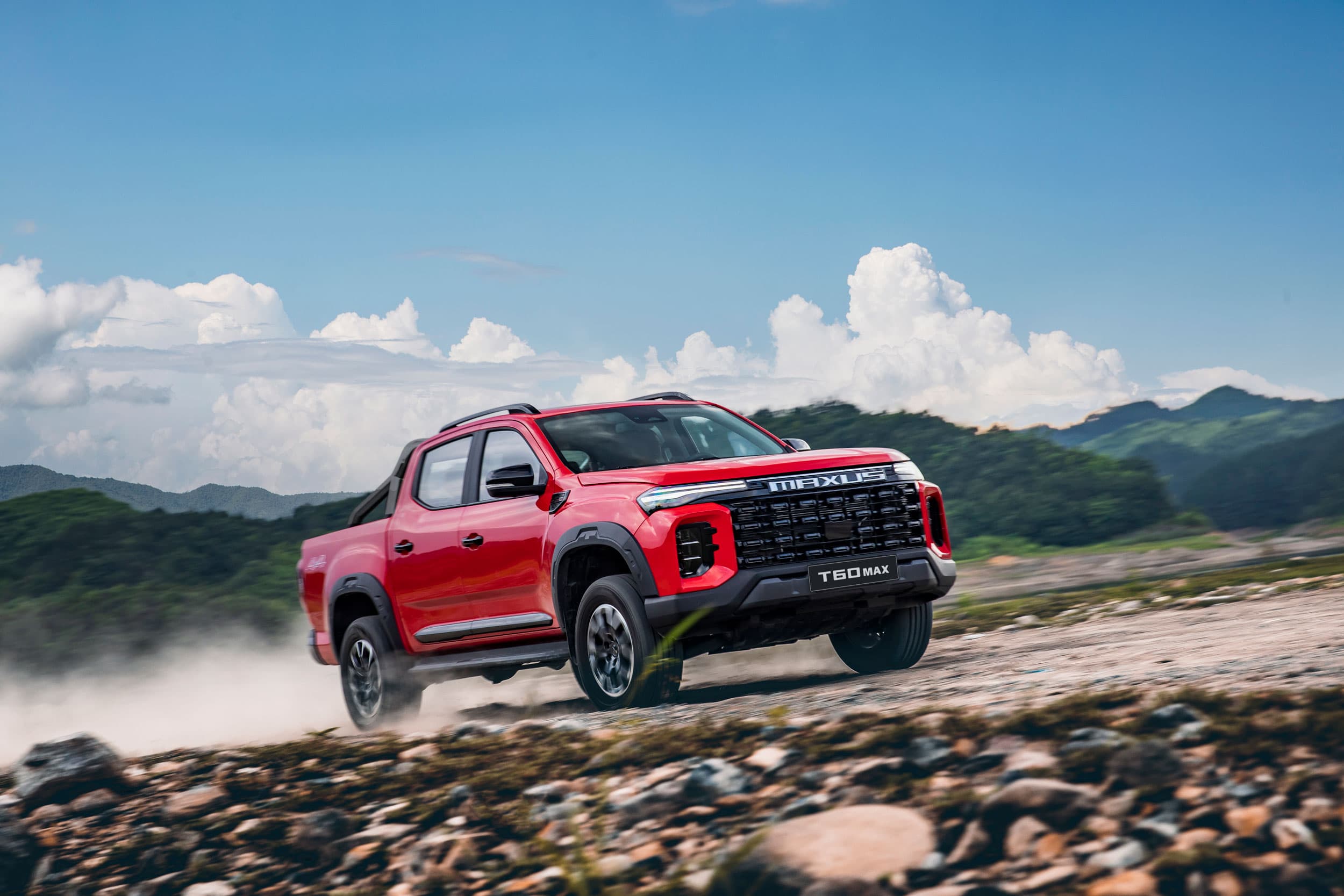 Maxus T60 Max driving on a dirt road (chinese red)